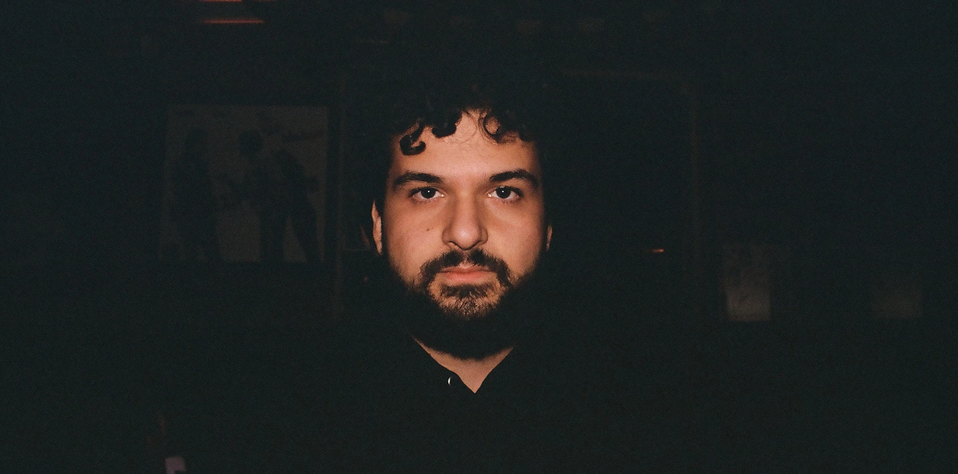 Portrait of Guy Ronen against a dark background