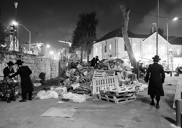 People gathered near street-side stalls at night