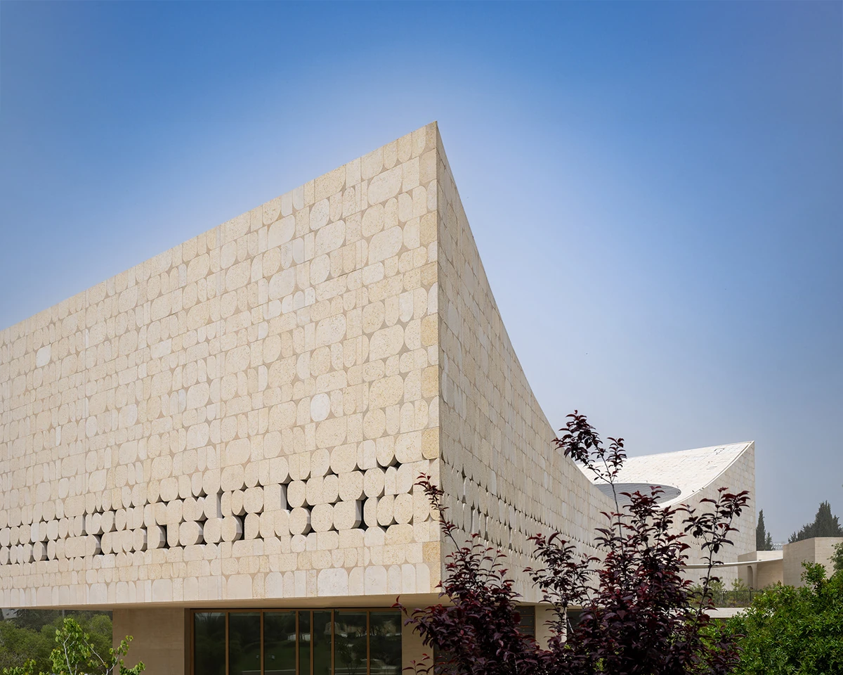 Angular limestone facade beneath a clear blue sky