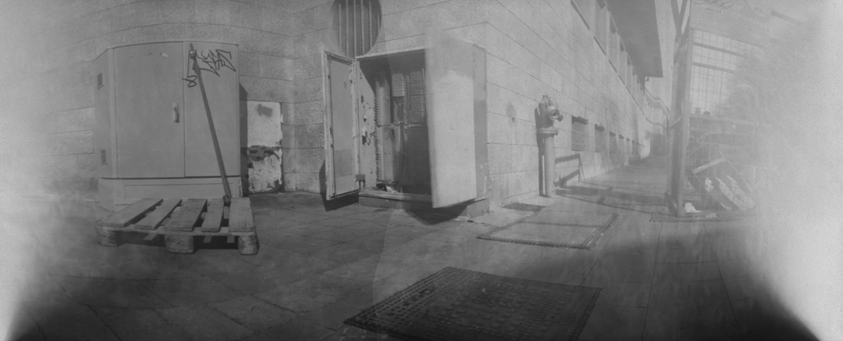 A weathered doorway with dark pinhole edges