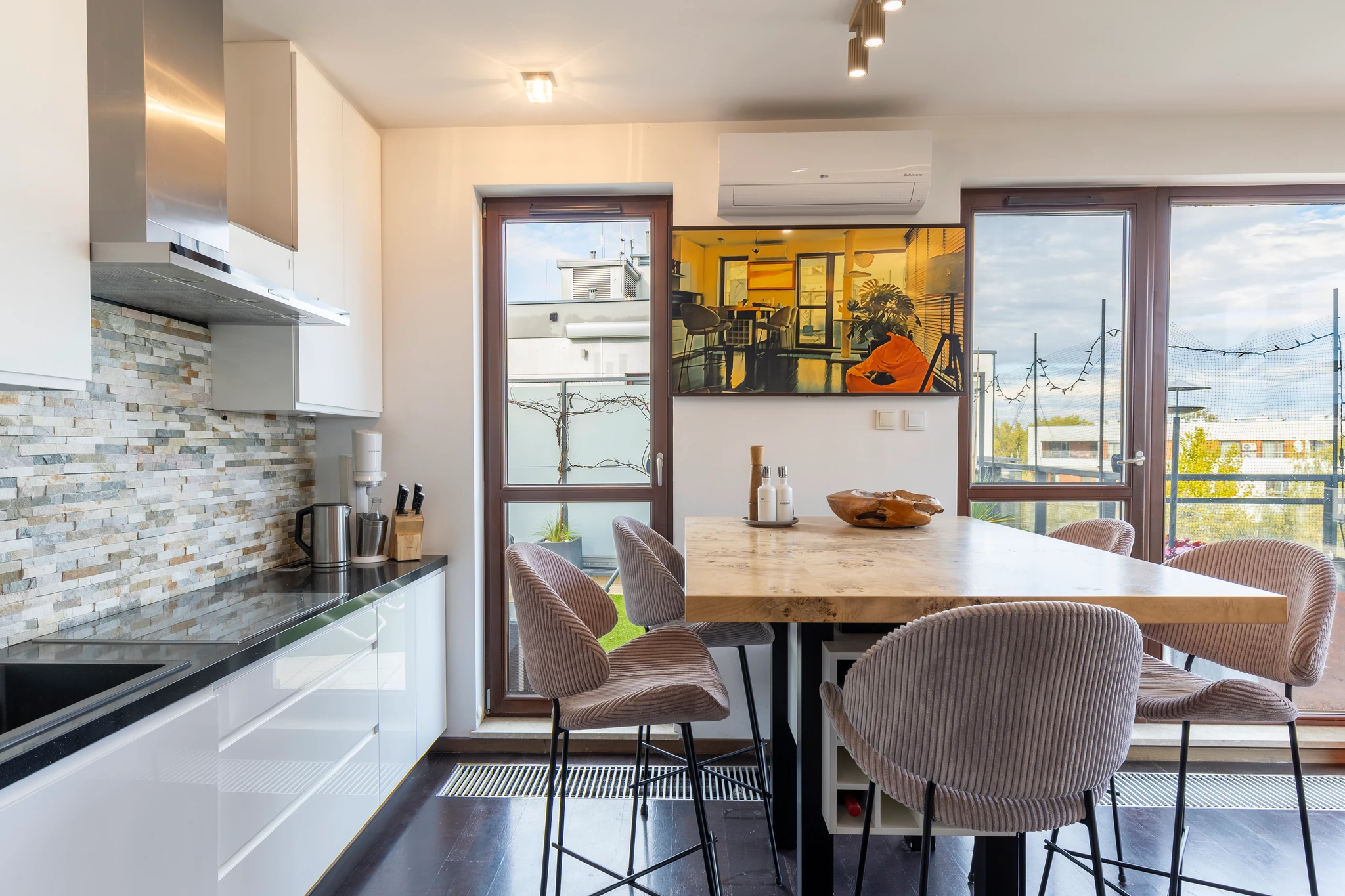 Kitchen and dining table beside balcony doors