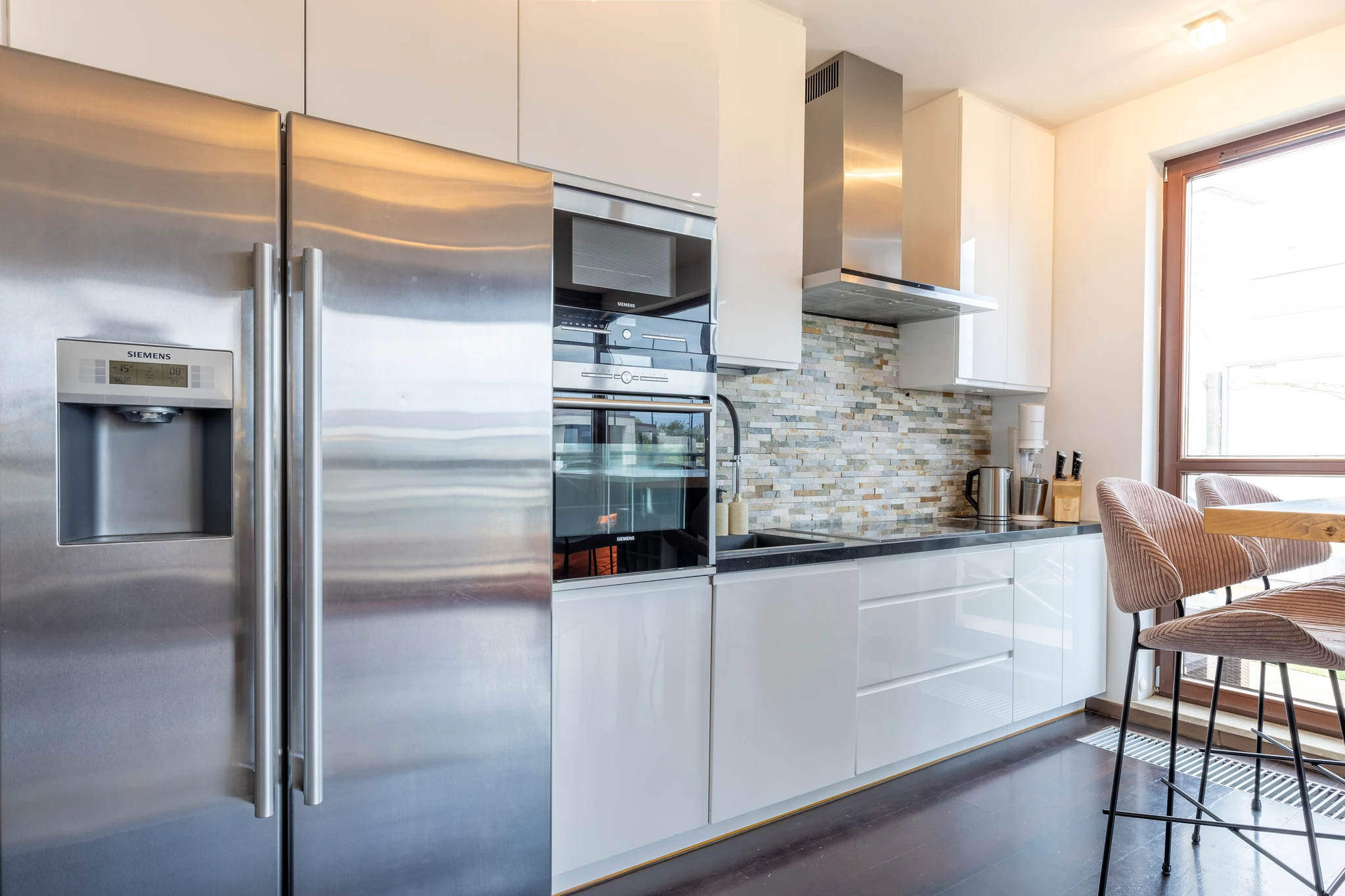 Kitchen with stainless steel appliances and white cabinets
