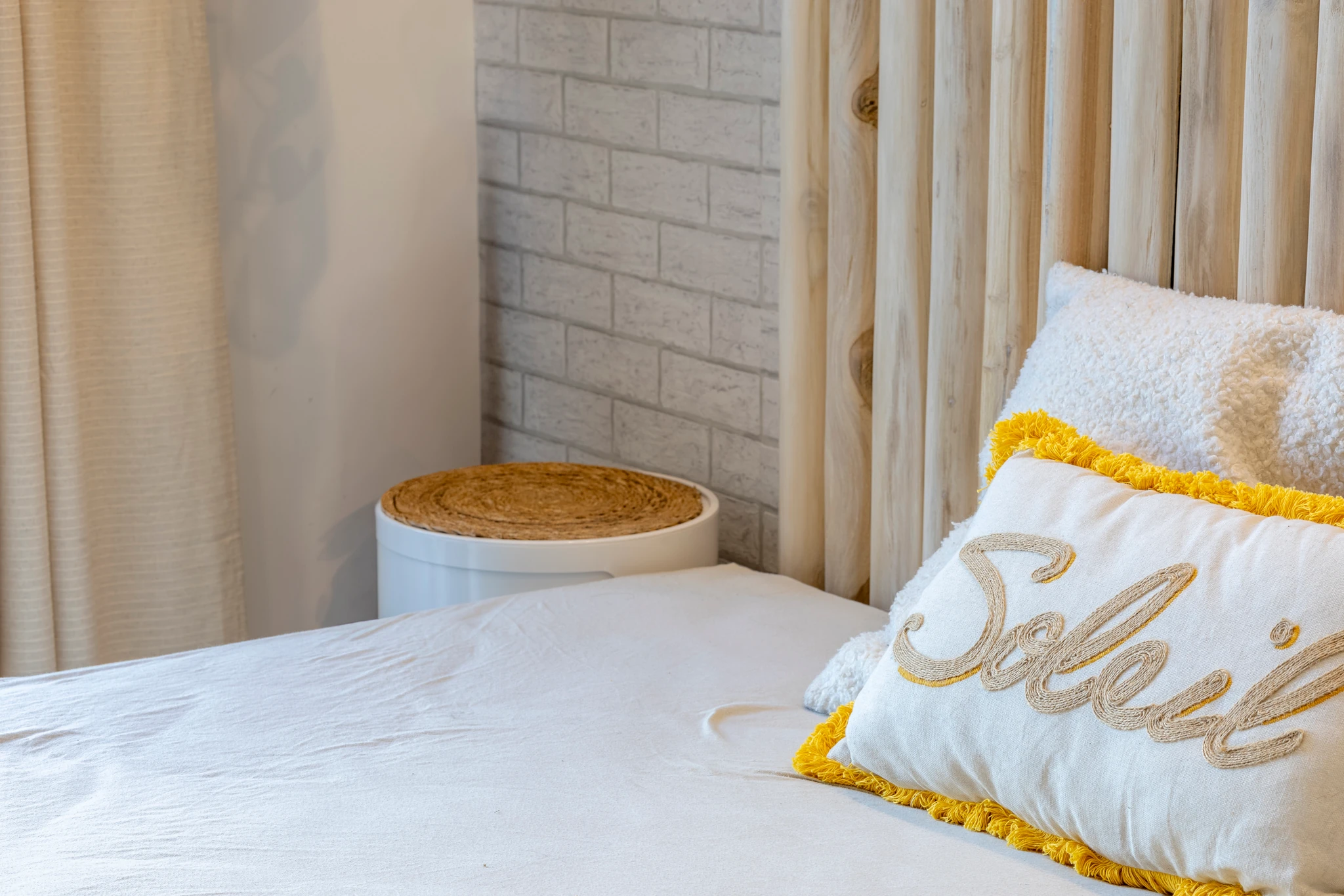 Bedroom details with pillows and a bedside table