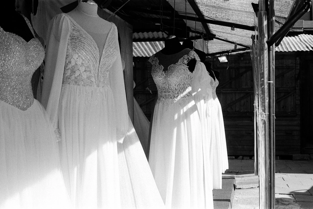 Wedding dresses hanging in a shop window